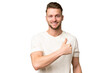 © luismolinero - Young blonde caucasian man over isolated background giving a thumbs up gesture