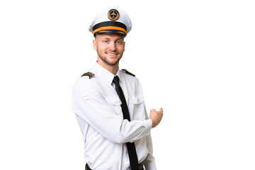 Wall Mural - Airplane pilot man over isolated background pointing back