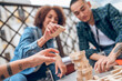 © zinkevych - Group of company employees playing jenga on the veranda