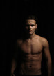 © velimir - man with an athletic body with a naked torso in the dark, a thin, athletic figure of a man.