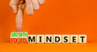 © Dzmitry - Growth or fixed mindset symbol. Concept words Growth mindset and Fixed mindset on wooden cubes. Businessman hand. Beautiful orange background. Business growth or fixed mindset concept. Copy space.