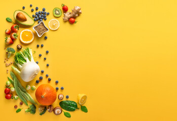 Wall Mural - Set of various vegetables, fruits and berries for healthy and diet food on a yellow background with copy space top view