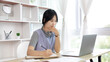 © Puwasit Inyavileart - Asian woman taking notes in notebook while studying online in laptop at home, Video chat, Online communication , Stay home, New normal, Distance learning.., Social distancing, Learn online...