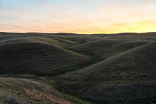 Sunset Over The Hills Of Grasslands National Park, Saskatchewan; Val Marie, Saskatchewan, Canada