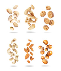 Wall Mural - Set of various dried nuts close-up in the air isolated on a white background