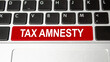 tax amnesty words on red keyboard button . tax concept