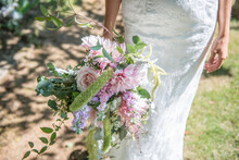 A Bride Holding A Bouquet Of Flowers On Her Wedding Day