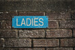 © Designpics - Blue sign 'Ladies' on a brick wall; Southwold, Suffolk, England