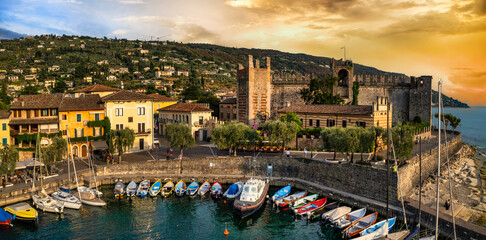 Canvas Print - Scenic places of beautiful lake Lago di Garda. aerial view of charming village Torri del Benaco and medieval castle. Italy, Verona province