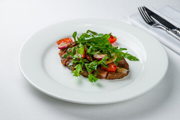 Sticker - juicy Ribeye steak with tomatoes and aragula on white plate sliced