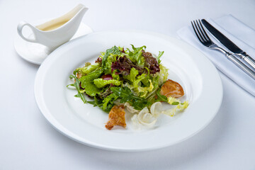 Wall Mural - salad with chicken with greenery on a white plate