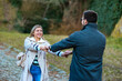 © DusanJelicic - Portrait of a couple walking in the park holding hands while laughing.