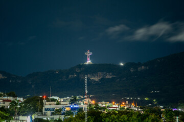 Large monument Cristo de Chiapas high in the mountains at night.