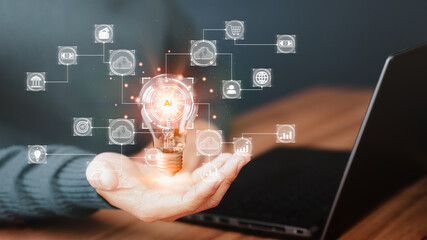 Poster - Man holding a light bulb while working on a laptop to think and create new ideas. Ai technology, cloud computing, technology bigdata and business process strategy and smart industry.