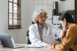 © Natee Meepian - Senior doctor assisting a woman in her office. the patient is crying and feeling hopeless