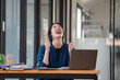 © Songsak C - Shot of a young businesswoman cheering while working on a laptop in an office.