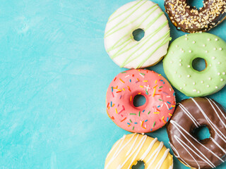 Wall Mural - donuts on blue background , copy space, top view