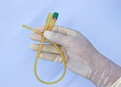 © Nisit - nurse holding urinary catheter prior to use.