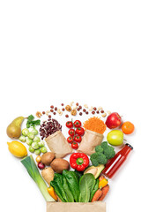 Wall Mural - Healthy food background. Healthy food in paper bag vegetables and fruits on white. Shopping food supermarket concept, food delivery. Copy space