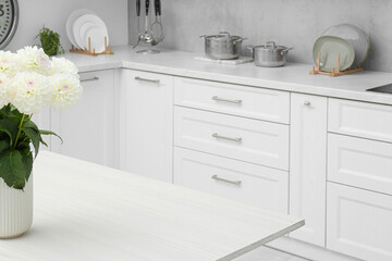 Sticker - Bouquet of flowers on stylish white wooden table in kitchen, space for text. Interior design