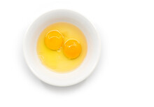 Isolated Raw Chicken Eggs, Top View Of Two Raw Egg Yolk In White Bowl On White Background.