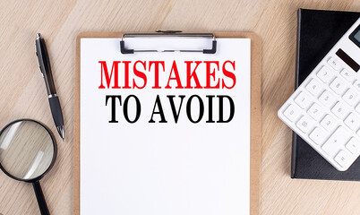 Poster - MISTAKES TO AVOID text on a clipboard on wooden background