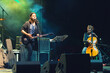 © Solid photos - Rock group playing on the live concert outdoor in summer. Guitar player, singer and cellist.