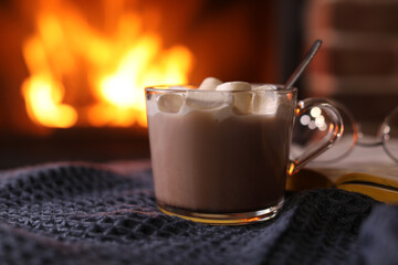 Sticker - Delicious sweet cocoa with marshmallows and blurred fireplace on background