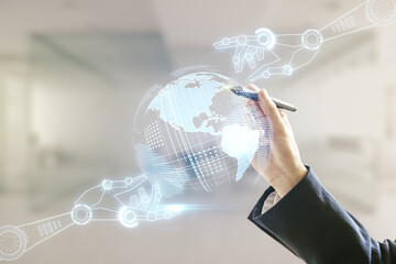 Aufkleber - Man hand with pen working with abstract virtual robotics technology hologram with globe sketch on blurred office background. Robot development and automation concept. Multiexposure