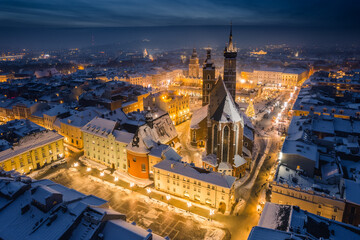 Wall Mural - Snow covered old town in Krakow with a view of the Christmas Market photographed in the blue hour.