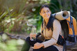 © Lune V A/peopleimages.com - Drinking water, hiking and backpack with an indian woman in nature for exercise or a recreation hobby. Fitness, forest and workout with a young female taking a break to relax during a hike outdoor