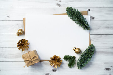 Wall Mural - Mockup for a letter or a Christmas invitation with gold fir cone	

