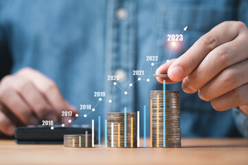 Businessman stacking money coins with up arrow and percentage symbol for financial banking increase interest rate or mortgage investment dividend from business growth concept.