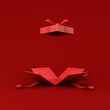 All red opening gift box blank opened present box with red ribbon bow isolated on dark red background for christmas valentines and chinese new year days decorations minimal conceptual 3D rendering