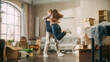 © Gorodenkoff - Family New Home Moving in: Happy Girlfriend Returns Home and Finds Her Happy Man Doing Unpacking, They Hug and Dance. Happy Couple in their Cozy Sunny Apartment. Mortgage Loan, Home Renovations