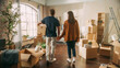 © Gorodenkoff - Family New Home Moving in: Happy and Excited Young Couple Enter Newly Purchased Apartment. Beautiful Family Happily Holding Hands. Modern Home Ready for Decorations