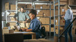 © Gorodenkoff - Establishing Shot of Multicultural Team of Warehouse Workers at Work in Internet Shop's Storeroom. Small Business Owners and Inventory Managers Working on Laptop, Tablet, Packing Parcels for Delivery.