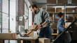 © Gorodenkoff - Busy Day at Warehouse. Multicultural Employees at Work in Retail Shop's Storeroom. Small Business Owners Working on Laptop, Preparing and Packing Parcels for Delivery.