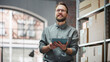 © Gorodenkoff - Portrait of a Happy Small Warehouse Employee Checking Inventory, Using Tablet. Handsome Man with Moustache Smiling in a Storeroom with Parcels and Online Purchased Orders Ready for Shipment.