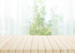 © hakinmhan - Selective focus.Empty of wood table top on blur of curtain with window and green from garden background.