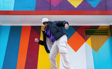 Stylish Man Dancing Near Colorful Building