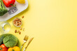 Proper nutrition concept. Top view photo of plate with vegetables knife fork almond cashew nuts glass of water and scales on isolated pastel yellow background with empty space