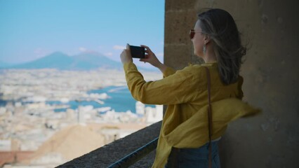 Wall Mural - Woman shoots views of Naples and Mount Vesuvius on her phone.