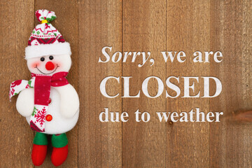 Wall Mural - Sorry we are closed due to weather sign with a snowman