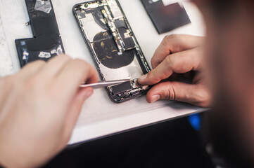 Poster - Cell phone repair at service center, smartphone disassembling and diagnostics, repairman workplace top view