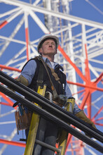 Cable Lineman Standing On A Ladder To Repair Transmission Line