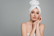 © LIGHTFIELD STUDIOS - pretty young woman with bare shoulders and towel on head isolated on grey
