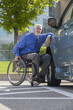 © Designpics - Man with muscular dystrophy and diabetes in a wheelchair beside an accessible van