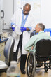 © Designpics - Two professors in a chemistry lab, one with a spinal cord injury, looking at a bottle of chemicals