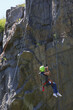 © Designpics - Man with spinal cord injury using adaptive climbing equipment for rock climbing
